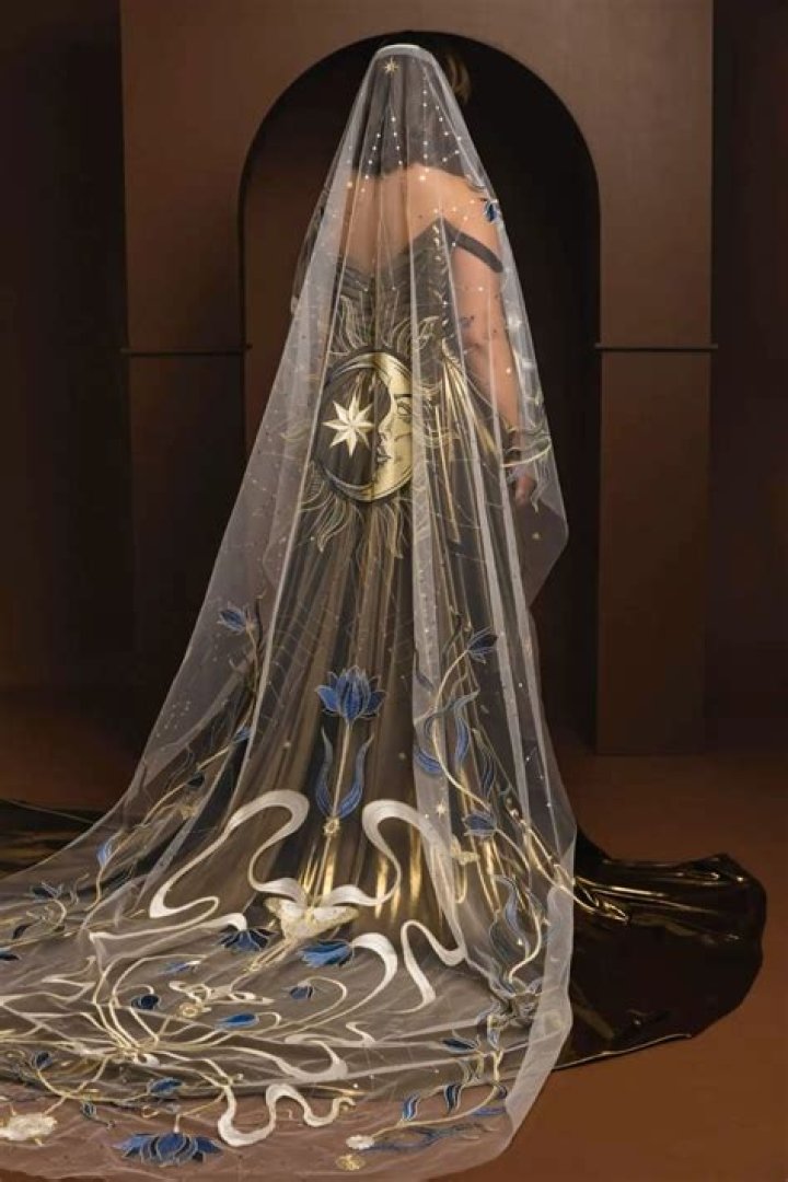 Glowing: Her long veil completed the look and she styled her blonde tresses into an up do while opting for glamorous makeup