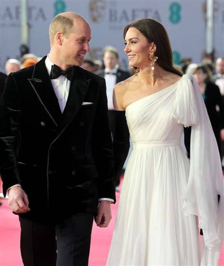 Prince William and Princess Kate walking hand and hand out of Westminster Abbey